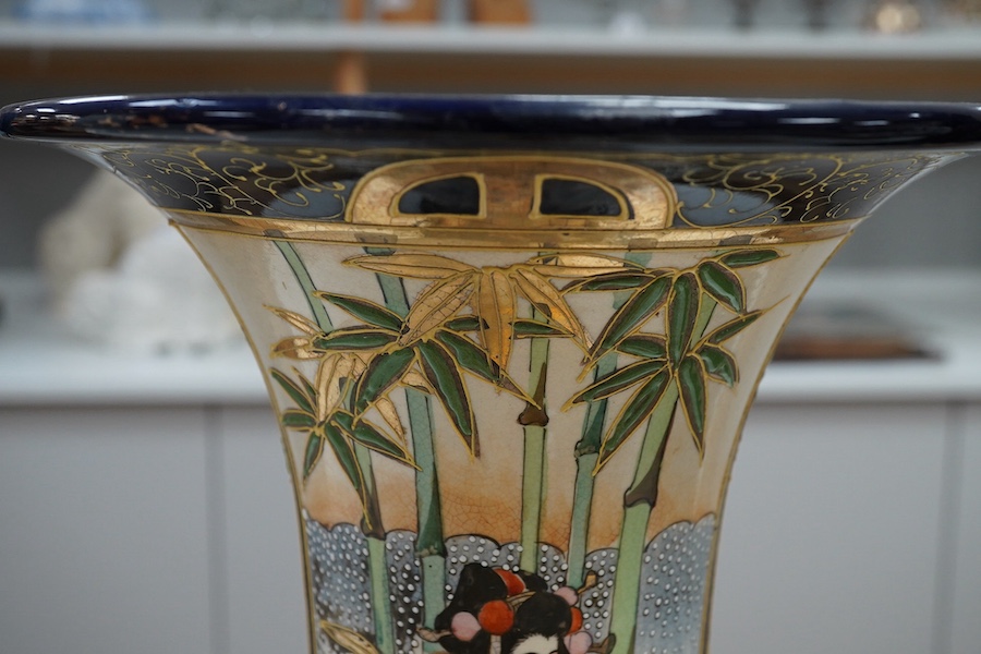A 20th century Japanese Satsuma pottery trumpet vase decorated with figures, 32cm high. Condition - crazed